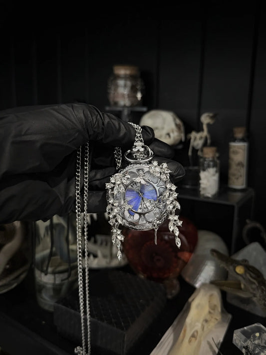 Purple Lepidora Entomology pocket watch with intricate design and classic round face, detailed close-up shot.